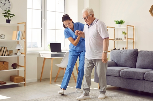 Care Professional helping elderly man with mobility after stroke