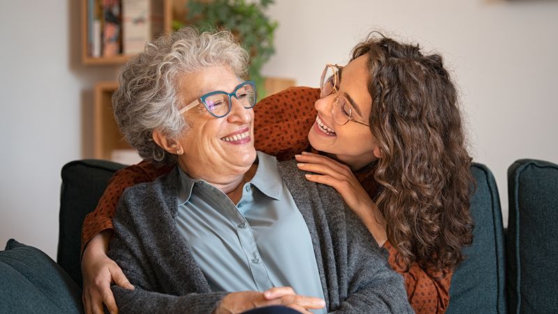 Adult son with aging father at kitchen table, Salt Lake City Utah home care
