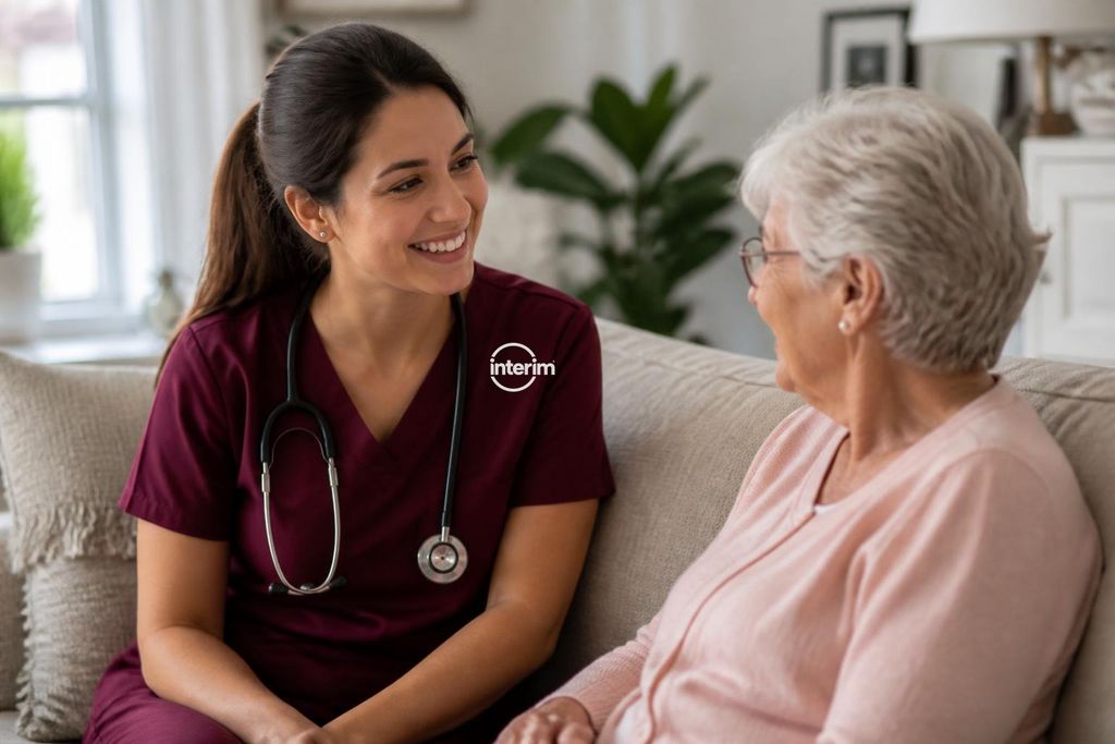 RN Care Professional providing skilled nursing support to a senior client at home.