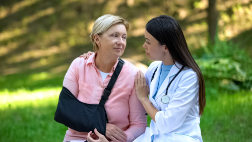 Care Professional supporting patient after shoulder surgery